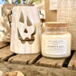 Natural Soy Wax Candle in a Clear Glass Apothecary-Style Jar and a Cork Lid. White Label on the Jar Reads "chester candle company. Fragrance No. 17. pumpkin & spice with hints of vanilla and brown sugar. 100% Natural Soy Wax, Cotton Wick, Natural Fragrance. 16 ounces 50-60 hours. Poured in Chester, NJ”